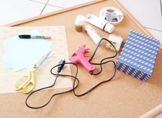 craft supplies laid out on top of a cork board