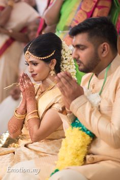 the bride and groom are sitting down for their wedding ceremony to be held in front of them