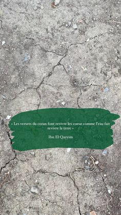 a green piece of paper that is laying on the ground with a quote written in it