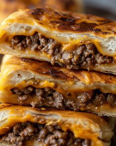 three quesadillas stacked on top of each other with cheese and ground beef