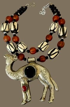 This rare and scarce tribal statement necklace is new and unworn from my private collection. It features a very hard to find Tibetan Repousse Camel pendant with inlaid black onyx and red carnelian. I remain uncertain about the small gold metal spor at the 11 o'clock position in the onyx, but I purchased the stone like this. The camel is as ornate on the back as it is on the front, and measures a lightweight 5.25" x 5" (the camel is hollow). The adjustable double strand beaded necklace ranges fro Artisan Black Ceremonial Jewelry, Artisan Black Jewelry For Festivals, Black Bohemian Necklace For Ceremonial Occasion, Traditional Black Necklaces With Large Pendant, Traditional Black Necklace With Large Pendant, Jewellery Shop Design, Turquoise Western, Red Carnelian, Chest Piece