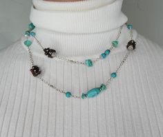 A real turquoise bead necklace is a stunning accessory that adds a touch of elegance and uniqueness to any outfit. Turquoise is a beautiful blue-green stone that has been treasured for centuries for its vibrant color and spiritual significance. When crafted into beads and strung together on a silver chain, it creates a striking piece of jewelry that can be worn for both casual and formal occasions. A long multi color necklace featuring turquoise stone beads offers a dynamic and eye-catching look. The combination of different color agate stone beads alongside the turquoise stone beads adds depth and visual interest to the necklace, making it a versatile accessory that can be paired with a variety of outfits. The silver chain complements the colors of the beads and adds a touch of sophistica Elegant Turquoise Long Necklace For Gift, Turquoise Long Necklace With Colorful Beads, Long Turquoise Necklace With Colorful Beads, Long Turquoise Necklace For Jewelry Making, Turquoise Long Necklace For Jewelry Making, Turquoise Long Beaded Chain Necklace, Elegant Turquoise Long Necklace With Round Beads, Turquoise Beaded Chain Long Necklace, Turquoise Long Necklace With Beaded Chain