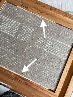 a close up of a wooden frame with an arrow pointing to the top and bottom