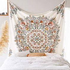 a bed with a large tapestry hanging over it's headboard