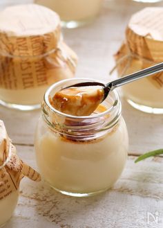 a jar filled with pudding sitting on top of a table next to other small jars