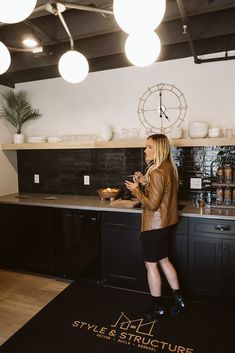 Go to the link to see more of Style & Structure's office. This break room has a built-in kitchenette with a sink, dish washer, microwave and fridge. The counters are gray quartz that looks like concrete. The backsplash is a handmade emerald green tile. Floating white oak shelf to stack white dishes and decor. 
Style & Structure is a custom home builder and renovator in Minnesota and Wisconsin. Modern Break Room, Salon Break Room, Break Room Refrigerator, Employee Kitchen Break Room, Small Breakroom Ideas, Office Kitchenette Ideas, Small Office Kitchen, Salon Break Room Ideas, Small Break Room Ideas