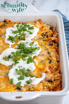 an enchilada dish with sour cream and cilantro