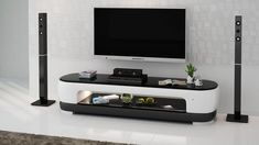 a flat screen tv sitting on top of a white entertainment center next to two speakers