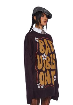 we're harsher than hell. This sweater has a knit construction, an oversized fit, ribbed trim, a crew neckline, and an intarsia "Bad Vibes Only" graphic and daisy pattern. Brown Crew Neck Sweater For Streetwear, Fall Crew Neck Sweater With Graphic Print, Oversized Knit Sweatshirt With Graphic Print, Fall Graphic Print Crew Neck Sweater, Fall Graphic Print Knit Sweater, Oversized Brown Sweater For Streetwear, Relaxed Fit Knit Sweater With Graphic Print, Graphic Print Knit Sweater For Fall, Knit Sweater With Graphic Print In Relaxed Fit