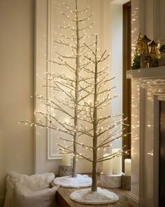 a white christmas tree with lights on it