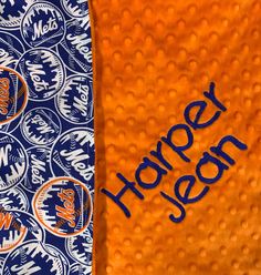 an orange and blue towel with the word honey written on it next to another one