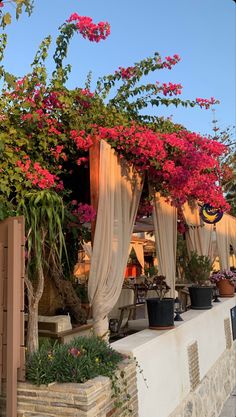 an outdoor dining area with flowers on the roof