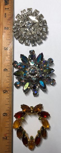 "Vintage Rhinestone Brooches Juliana Style. The blue brooch measures 2\" in diameter. The white circle brooch measures 1 1/2\" in diameter. The yellow rhinestone brooch measures 2\" long x 1 1/2\" wide. All my jewelry items are purchased through auctions or sales. Please see the pictures. This is what you will receive. Thank you!" Blue Brooch, Juliana Jewelry, Vintage Rhinestone Brooch, White Circle, Rhinestone Brooches, Vintage Rhinestone, Large Flowers, Flower Pendant, Flower Brooch