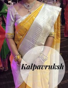 a woman wearing a yellow and white sari