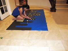 a woman kneeling down on top of a blue rug