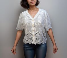 Enhance your wardrobe with this charming Crochet White Crop Top for Women, designed with a delicate scalloped ruffle edge and a flattering V-neck. This lightweight blouse features intricate crochet lacework that adds a touch of elegance and femininity, perfect for layering or wearing on its own.  SIZE: Free Size (suitable for girls who weigh 45-65kg) Bust: 40 inch Sleeve: 11.5 inch (Half Sleeves) Length: 21.5 inch The open-front style of the crochet lace cardigan makes it versatile and easy to p Crochet Lace Cardigan, Edge Crochet, Crop Top For Women, Intricate Crochet, Crochet White, White Cotton Blouse, Lace Cardigan, Blouse For Women, Top For Women