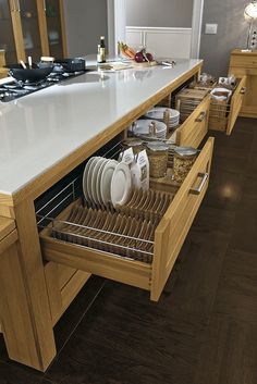 an open drawer in the middle of a kitchen counter