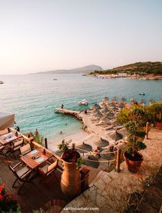 an outdoor dining area overlooking the water and beach