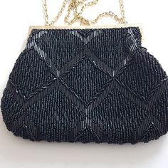 "Vintage black beaded evening bag with gold-tone metal chain strap.  Use the gold tone double chain and hang from the wrist or slide the chain and hang from the shoulder (would sit about the upper arm) Kiss lock at the top. Gold tone metal bracket. Lined with black and a handy pocket on one side. Size:  7\" (L) x 6\" (H) x 8.5\" drop was double chain to 15\" as single chain Tag:  \"Hand Made in Hong Kong\" Vintage Condition:  NO rips. NO tears. Handy link to other purses: https://www.etsy.com/ca/shop/ahummingbirdheirloom?search_query=purse Handy link for other evening bags: https://www.etsy.com/ca/shop/ahummingbirdheirloom?search_query=evening+bag Props are not included CANADA - Prices include HST/GST. Any applicable PST/RST/QST added at checkout. USA - Taxes added at checkout More vintage Beaded Evening Bags, Beaded Purses, Double Chain, Canada Post, Clutch Handbag, Black Beads, Metal Chain, Gold Tone Metal, Chain Strap