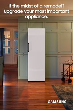 a white refrigerator freezer sitting in the middle of a kitchen next to a wooden floor