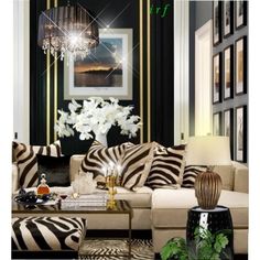 a living room with zebra print furniture and chandelier hanging from the ceiling,