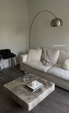 a living room with a white couch and coffee table