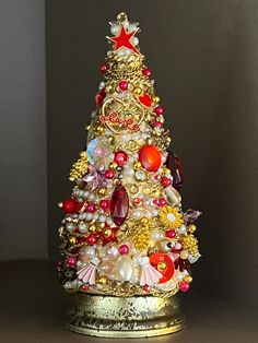 a small christmas tree with lots of ornaments on it