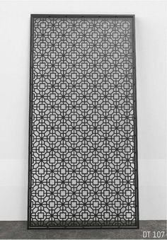 a black and white photo of a decorative screen