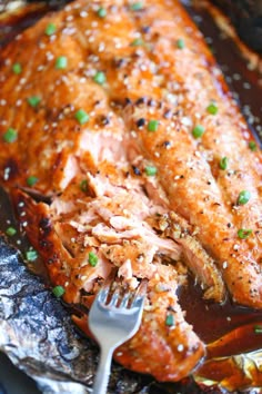 a piece of salmon is being cut with a fork