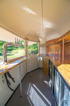 the inside of an rv with wood cabinets and counter tops on both sides is shown