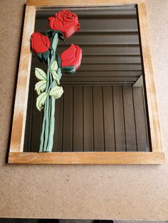 a mirror that has some flowers in it