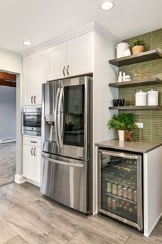 a kitchen with stainless steel appliances and white cabinets