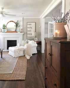 a living room filled with furniture and a fire place in the middle of the room