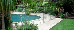 an empty swimming pool surrounded by lush green trees