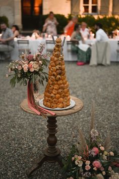 a table with food on it and people sitting at tables in the background