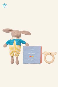 a stuffed animal next to a book and ring