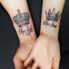 two people with matching tattoos on their arms holding each other's hands and one has a crown