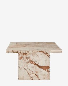 a white marble table with brown veining on the top and bottom, against a white background