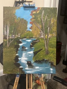 an easel holding up a painting of a river