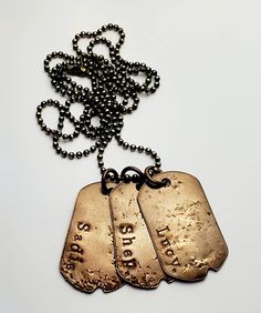 "A three dog tag necklace is made of all U.S. made brass components, including the hand stamped dog tags and the ball chain. All metals are oxidized (darkened for a deep bronze/brown contrasting finish) and polished to best showcase the hand stamping on each tag. Choose your font and text for each tag. Please specify details in the message area at checkout. * * * PLEASE NOTE: DOG TAGS ARE SMALLER THAN STANDARD U.S. MILITARY ISSUE SIZE * * * MEASUREMENTS: DOG TAG measures: approximately 31 mm x 1 Stamped Dog Tags, Three Dog, Man Necklace, Brass Components, Brass Pendants, Japanese Dogs, Three Dogs, Necklace For Men, Dog Tag