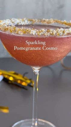 the sparkling pomegranate cosmo cocktail is garnished with gold flakes