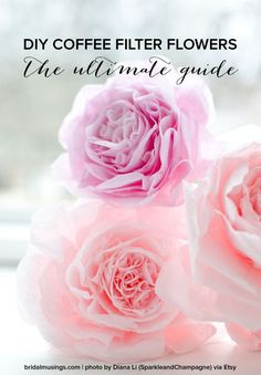 three pink flowers sitting on top of a white table next to a window sill