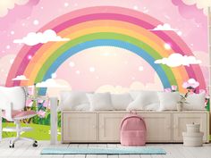 a room with a rainbow wall mural in the background