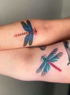 two matching dragon tattoos on both arms, one is blue and the other is red