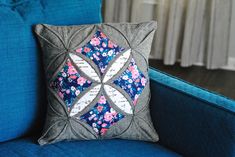 a blue couch with a decorative pillow on it