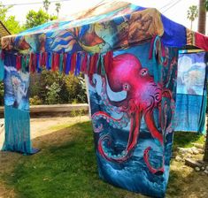 an octopus themed tent is set up in the grass