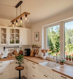 a kitchen filled with lots of counter top space and wooden counters topped with pots and pans