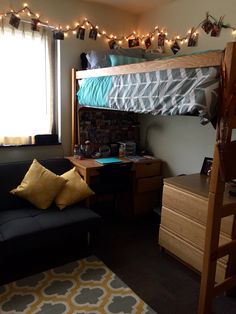 a loft bed with lights strung above it