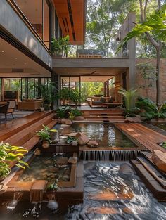 the inside of a modern house with a waterfall in the center and wooden steps leading up to it