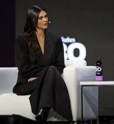 a woman sitting on top of a white couch